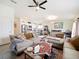 Inviting living room featuring comfortable seating, ceiling fan, and ample natural light at 2894 Mosshire Cir, Saint Cloud, FL 34772
