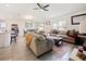 Open-concept living room with adjacent dining area and view of the kitchen at 2894 Mosshire Cir, Saint Cloud, FL 34772