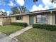 Condo exterior, featuring a green door and landscaping at 725 Northlake Blvd # 52, Altamonte Springs, FL 32701