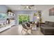 Living room with gray sectional, wood chair, and sliding glass doors at 4801 Sparkling Shell Ave, Kissimmee, FL 34746