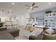 Open concept living room with a sectional sofa and access to the kitchen at 4801 Sparkling Shell Ave, Kissimmee, FL 34746