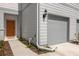 Townhouse exterior showcasing the gray siding and orange door at 4801 Sparkling Shell Ave, Kissimmee, FL 34746