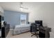 Bright bedroom with a bed, desk, and window at 4801 Sparkling Shell Ave, Kissimmee, FL 34746