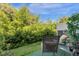Private backyard with lush greenery and seating at 4801 Sparkling Shell Ave, Kissimmee, FL 34746
