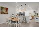 Bright dining area with a wooden table and white chairs at 4801 Sparkling Shell Ave, Kissimmee, FL 34746