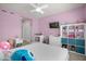 Second bedroom with built-in shelving and TV at 4801 Sparkling Shell Ave, Kissimmee, FL 34746