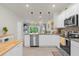 Open concept kitchen, island, stainless steel appliances and view into living room at 4801 Sparkling Shell Ave, Kissimmee, FL 34746