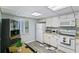 Well-equipped kitchen featuring white cabinetry and modern appliances at 15 Escondido Cir # 141, Altamonte Springs, FL 32701