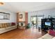 Living area with hardwood floors, fireplace, and access to patio at 15 Escondido Cir # 141, Altamonte Springs, FL 32701