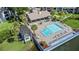 Aerial view of community pool, clubhouse, and lush landscaping at 15 Escondido Cir # 141, Altamonte Springs, FL 32701