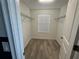 Spacious walk-in closet with wood-look flooring and ample shelving at 11845 Ginsberg Pl, Orlando, FL 32832