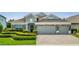 Two-car garage and welcoming front porch enhance this beautiful home's exterior at 12151 Alder Branch Loop, Orlando, FL 32824