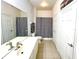 Bathroom with a bathtub, toilet, and double vanity at 6335 Contessa Dr # 205, Orlando, FL 32829