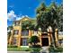 Exterior of a two-story apartment building with lush landscaping at 6335 Contessa Dr # 205, Orlando, FL 32829
