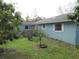 Back of house, light blue, with a yard and fruit trees at 1632 N Fullers Cross Rd, Winter Garden, FL 34787