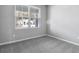 Spacious bedroom with gray walls, gray carpeting, and a large window at 4236 Sawtooth Ct, Tavares, FL 32778