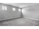 Bedroom with gray walls, gray carpet, and three windows at 4236 Sawtooth Ct, Tavares, FL 32778