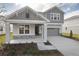 Two-story house with gray siding, stone accents, and a two-car garage at 4236 Sawtooth Ct, Tavares, FL 32778