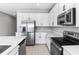 Modern kitchen with white cabinets, stainless steel appliances, and an island at 4236 Sawtooth Ct, Tavares, FL 32778