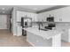 Modern kitchen with white cabinets, stainless steel appliances, and a large island at 4236 Sawtooth Ct, Tavares, FL 32778
