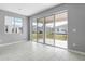 Living room with sliding glass doors to the backyard and tile floors at 4236 Sawtooth Ct, Tavares, FL 32778