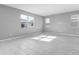 Bright living room with gray walls, tile floors, and multiple windows at 4236 Sawtooth Ct, Tavares, FL 32778