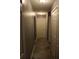 Long hallway with neutral walls and tile floors at 624 Gull Dr, Poinciana, FL 34759