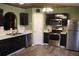 Kitchen with stainless steel appliances and dark wood cabinets at 624 Gull Dr, Poinciana, FL 34759