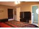Main bedroom with large TV and ensuite bathroom access at 624 Gull Dr, Poinciana, FL 34759