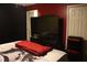 Bedroom with large TV and red bedding at 624 Gull Dr, Poinciana, FL 34759