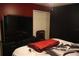 Bedroom with large TV and red bedding at 624 Gull Dr, Poinciana, FL 34759