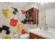 Bathroom with Mickey Mouse shower curtain and storage cabinet at 500 Playa Dr, Davenport, FL 33837