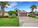 House exterior with palm trees and a brick driveway at 500 Playa Dr, Davenport, FL 33837