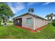 House exterior showcasing a side view, landscaping, and patio at 500 Playa Dr, Davenport, FL 33837