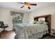 Comfortable bedroom with a queen-size bed and ceiling fan at 500 Playa Dr, Davenport, FL 33837