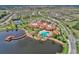 Aerial view of community with pool, clubhouse, and lake at 500 Playa Dr, Davenport, FL 33837