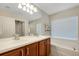 Double vanity bathroom with soaking tub and large mirror at 500 Playa Dr, Davenport, FL 33837