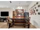 Charming dining area with a wooden table, bench seating, and decorative plates at 500 Playa Dr, Davenport, FL 33837