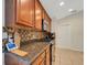 Kitchen boasts granite countertops, wood cabinets, and stainless steel appliances at 500 Playa Dr, Davenport, FL 33837