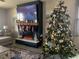Cozy living room with a fireplace, decorated for the holidays at 2867 Matera Dr, St Cloud, FL 34771
