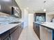 Modern kitchen with dark cabinets and stainless steel appliances at 3510 Mediterra Dr, Clermont, FL 34711