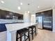 Modern kitchen with dark cabinetry, quartz countertops, and stainless steel appliances at 3510 Mediterra Dr, Clermont, FL 34711