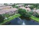 Aerial view of apartment buildings near a lake with a fountain at 8842 Villa View Cir # 205, Orlando, FL 32821