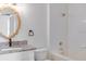 Bathroom with granite countertop, white cabinets, and bathtub shower at 8842 Villa View Cir # 205, Orlando, FL 32821