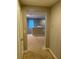 Upstairs hallway with carpeted floors and access to other rooms at 11460 Chateaubriand Ave, Orlando, FL 32836