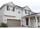 Two-story home with gray siding, gray garage door, and white columns at 11460 Chateaubriand Ave, Orlando, FL 32836
