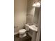 Small bathroom with pedestal sink and toilet at 11460 Chateaubriand Ave, Orlando, FL 32836