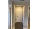 Well-lit hallway with tile floors and neutral colors at 11460 Chateaubriand Ave, Orlando, FL 32836