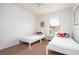 Well-lit bedroom with two twin beds, nightstand, and ceiling fan at 8545 Bay Lilly Loop, Kissimmee, FL 34747