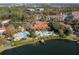 Aerial view showing resort-style pool, lake, and clubhouse at 8545 Bay Lilly Loop, Kissimmee, FL 34747